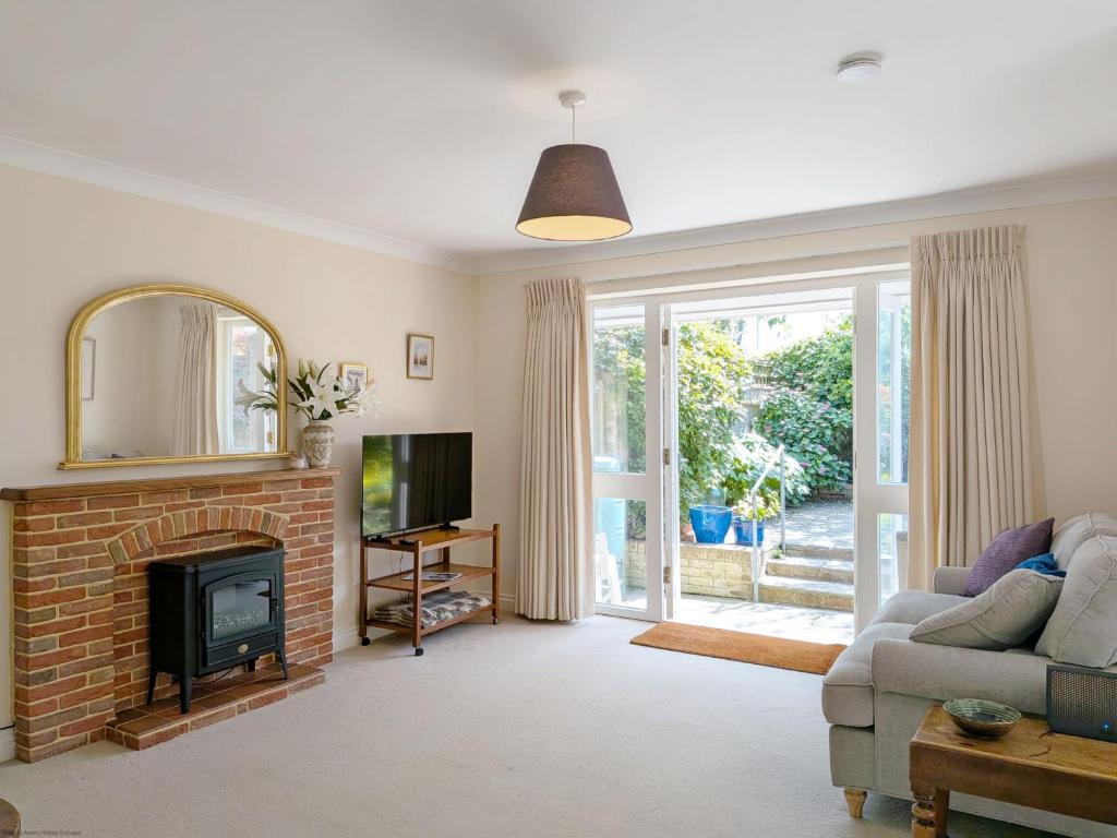a living room with a couch and a fireplace at Apple Cottage - Emsworth in Emsworth