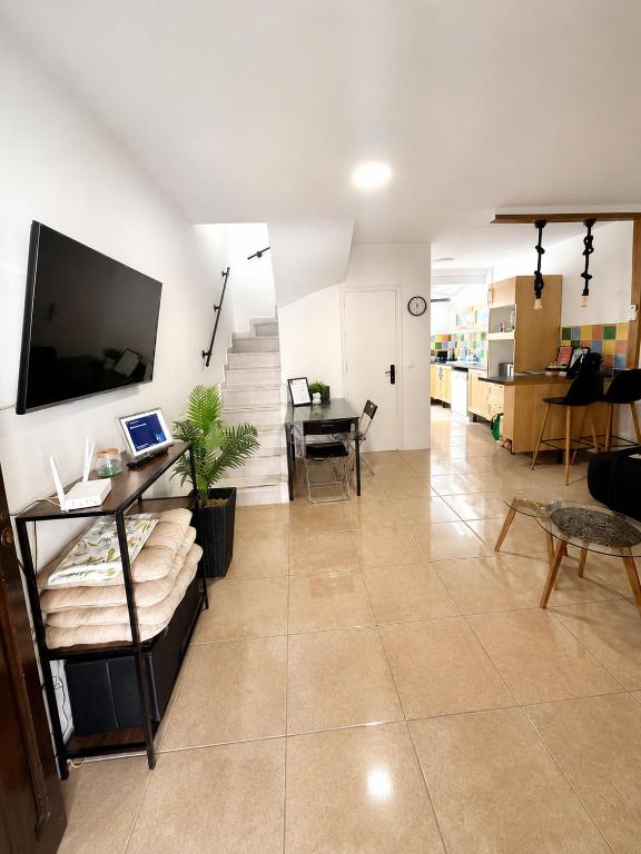a large living room with a television and a table at Villa Richmond in Gran Alacant