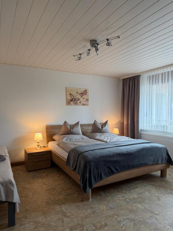 a bedroom with a large bed and a ceiling at Gemütliche Ferienwohnung in Worbis in Worbis