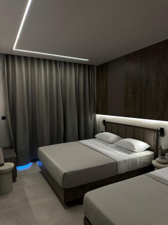 a hotel room with two beds and a light at Aelith Rooms in Platamonas