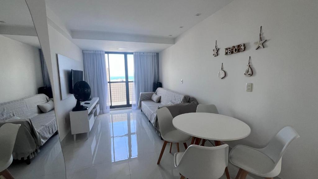 a living room with a table and a couch at Cobertura Ponta Verde Vistar Mar in Maceió