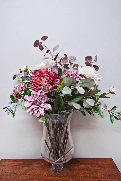 a vase filled with flowers sitting on a table at Rundu B&B in Rundu