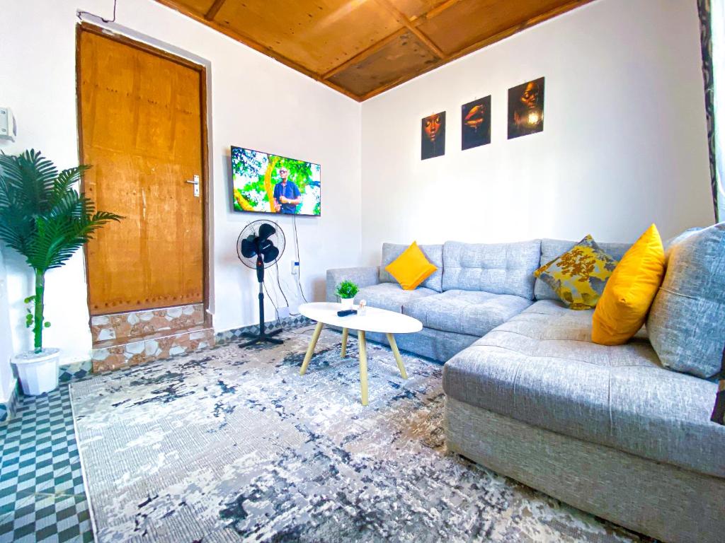 a living room with a couch and a table at KL beach road Diani in Ukunda