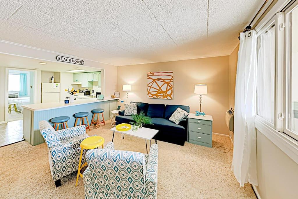 a living room with a couch and a kitchen at Colonial Unit 202 in Ocean City