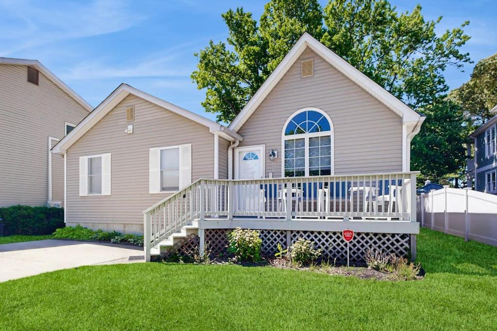 a house with a white railing on the front porch at Sunny Day in Ocean City