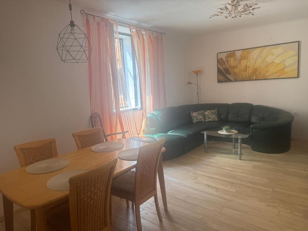 a living room with a couch and a dining room table at 3 bedroom Apartman Izolana in Izola