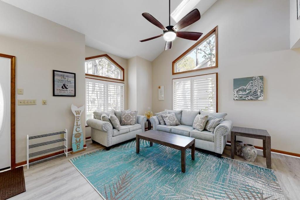 a living room with two couches and a ceiling fan at Trinity Place Treasure in Ocean Pines