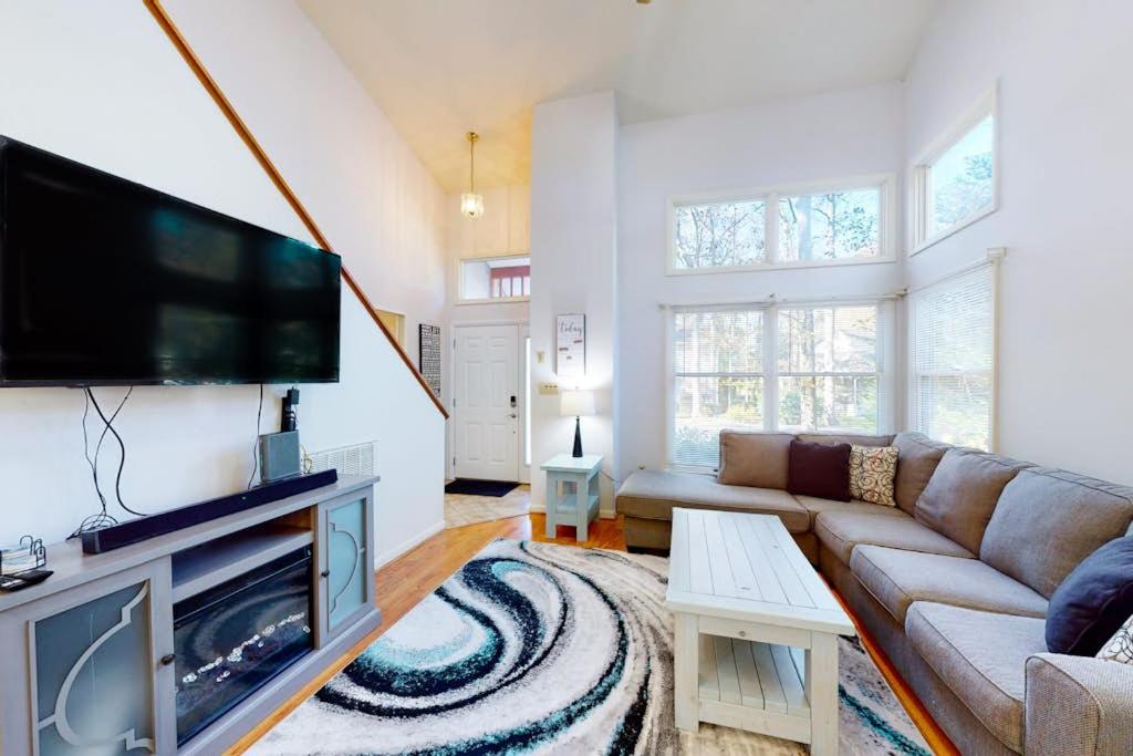 a living room with a couch and a flat screen tv at 5 Whitecap in Ocean Pines