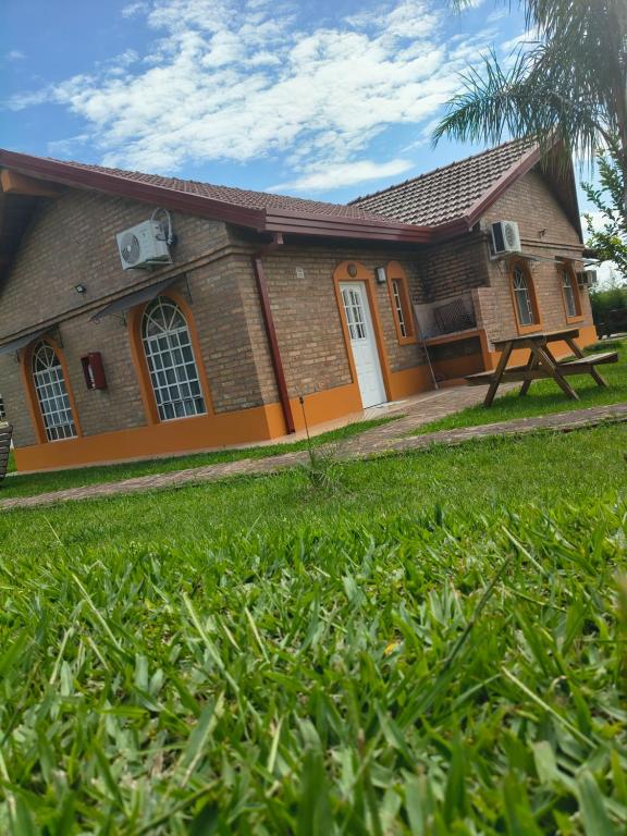 a house with a green lawn in front of it at Cabaña 6D in Concordia