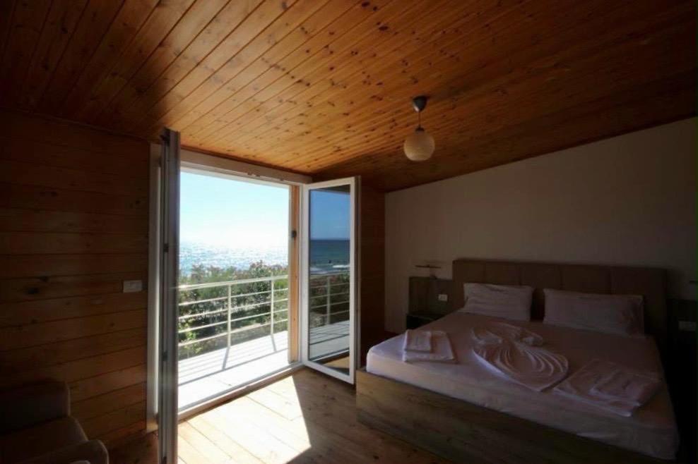 a bedroom with a bed with a view of the ocean at Shengjin villa in Shëngjin