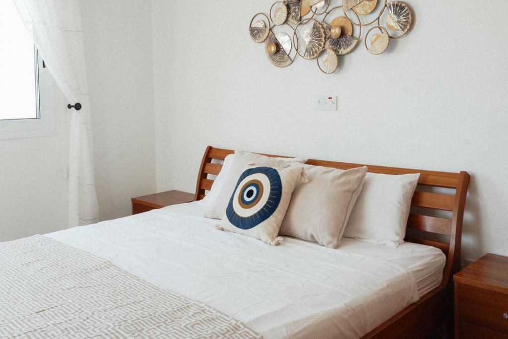 a bedroom with a bed with a target on the wall at Chloraka Sea View Apt with Pool in Khlorakas