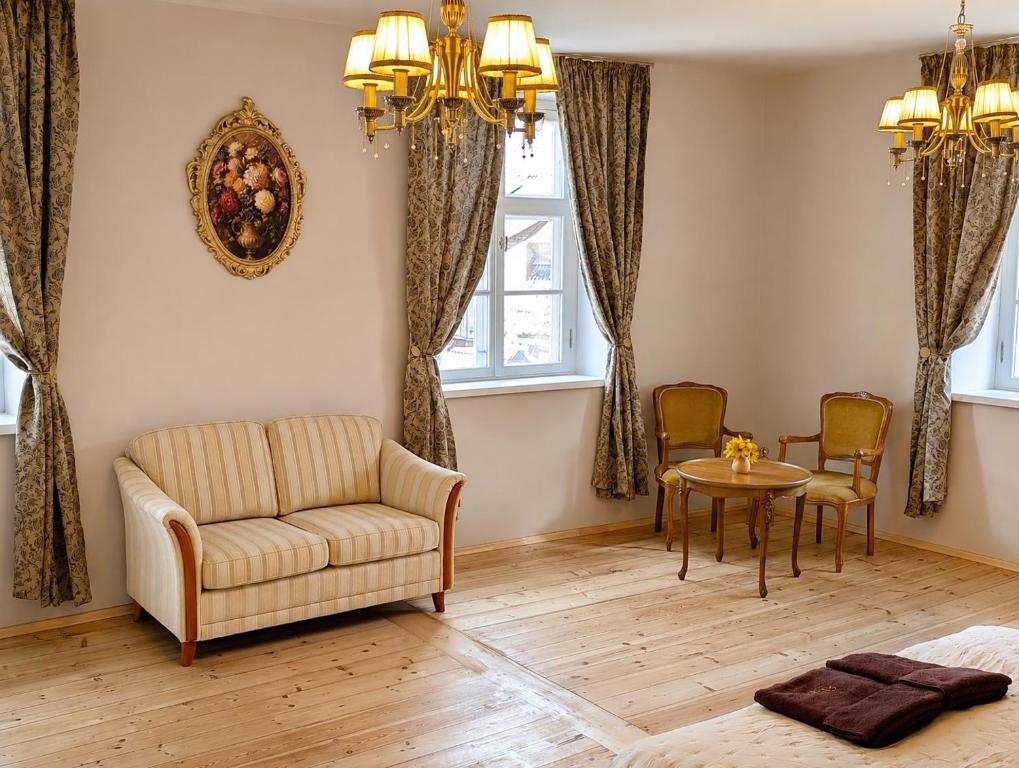 a living room with a couch and a table at Arāja apartamenti in Kuldīga