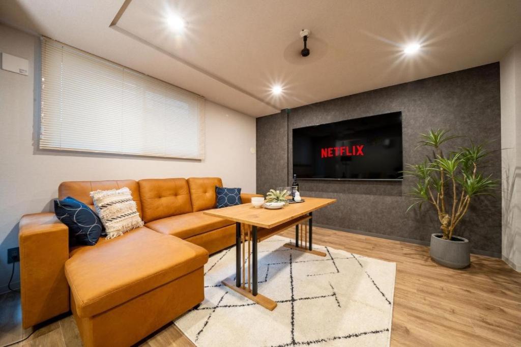 a living room with a couch and a table at Lotus south in Sapporo