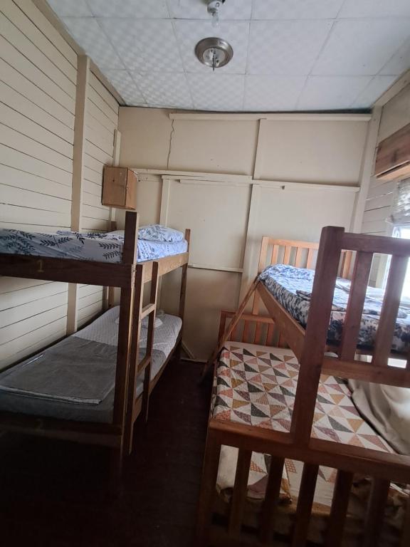 a small room with two bunk beds in it at Hostal South beach in Carenero
