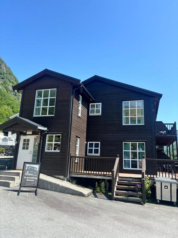 a black house with a sign in front of it at Røldal Overnatting in Røldal