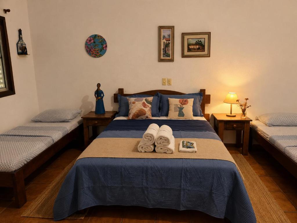 a bedroom with two beds with towels on the bed at POUSADA SERRA DA CANASTRA in Delfinópolis