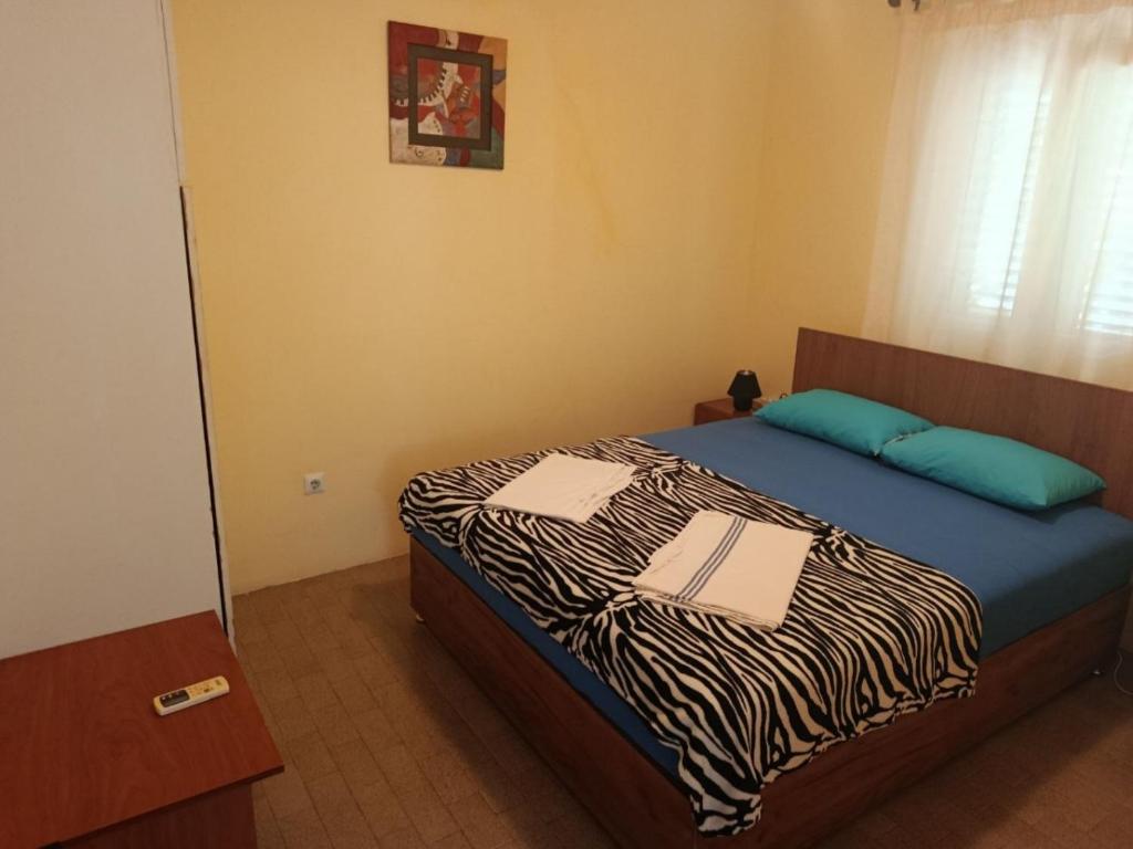 a bedroom with a zebra print bed with a mirror at Zorica in Rafailovici