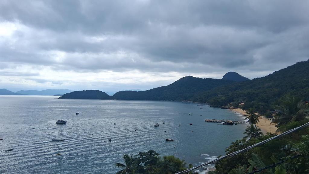 a view of a beach with boats in the water at Hotel Nacional in Rio de Janeiro