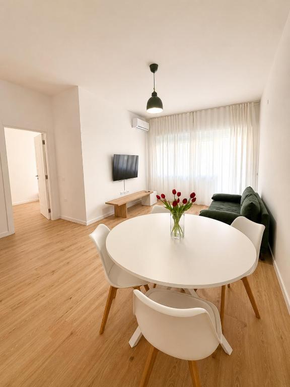 a living room with a white table and chairs at Casa Granata in Caserta