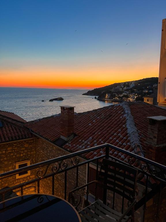 a view of the ocean at sunset from a building at Apartments Debora in Ulcinj