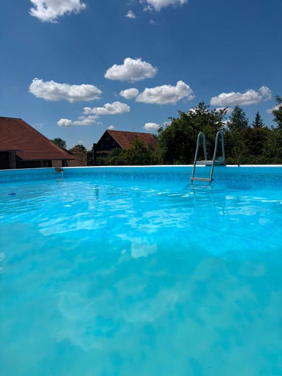 a large swimming pool with blue water at Bohemica Apartman 4 in Kouřim