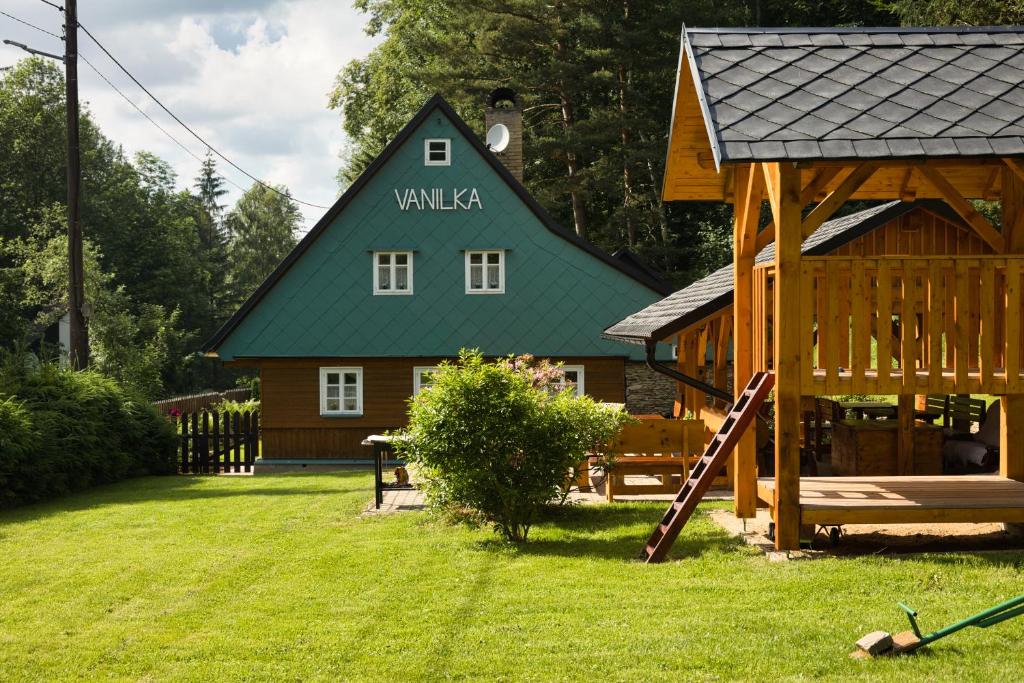 a large wooden house with a green roof at Chata Vanilka in Bělá pod Pradědem
