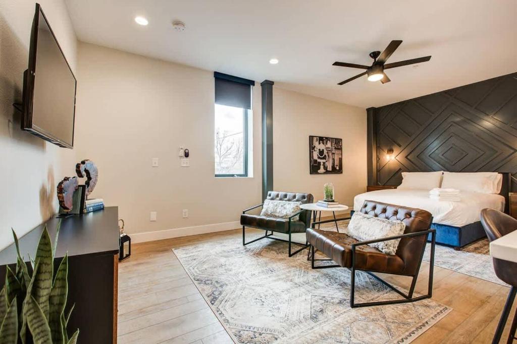 a bedroom with a bed and a living room at Modern ADA-Accessible Studio - Tennyson St Escape in Denver