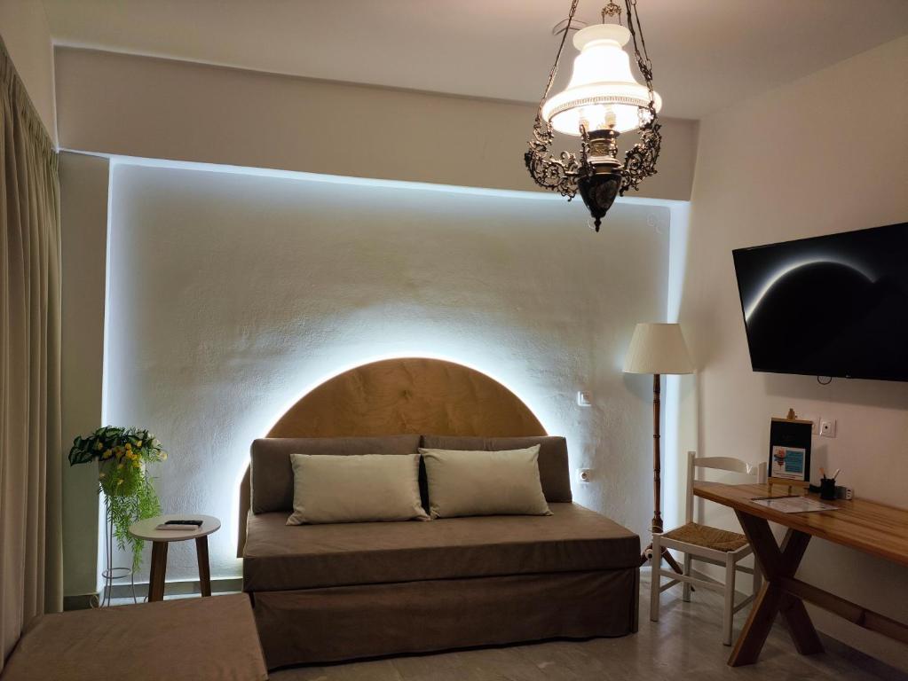 a living room with a couch and a table at Malia Beelight - Family & Groups in Malia