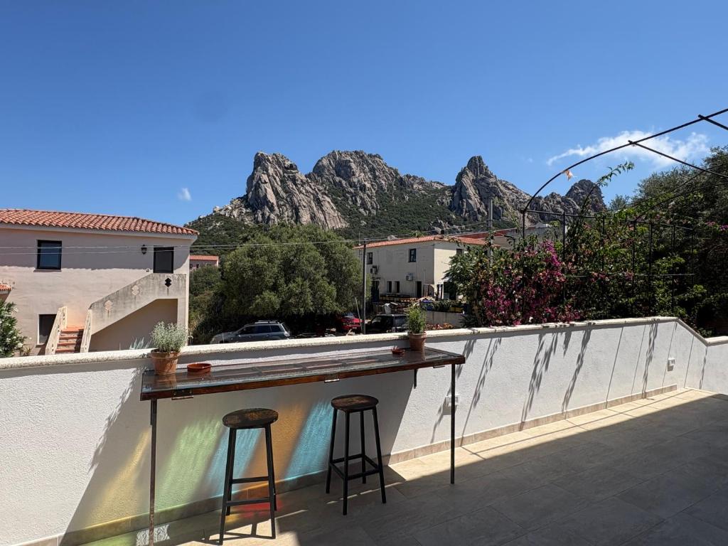 a bar on the roof of a building with two stools at Minnanni in San Pantaleo