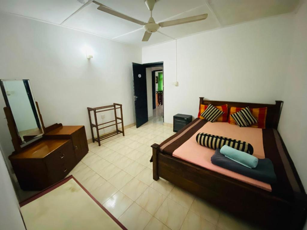 a bedroom with a bed and a dresser in it at Cloud Inn Kandy Homestay - Near temple tooth in Kandy