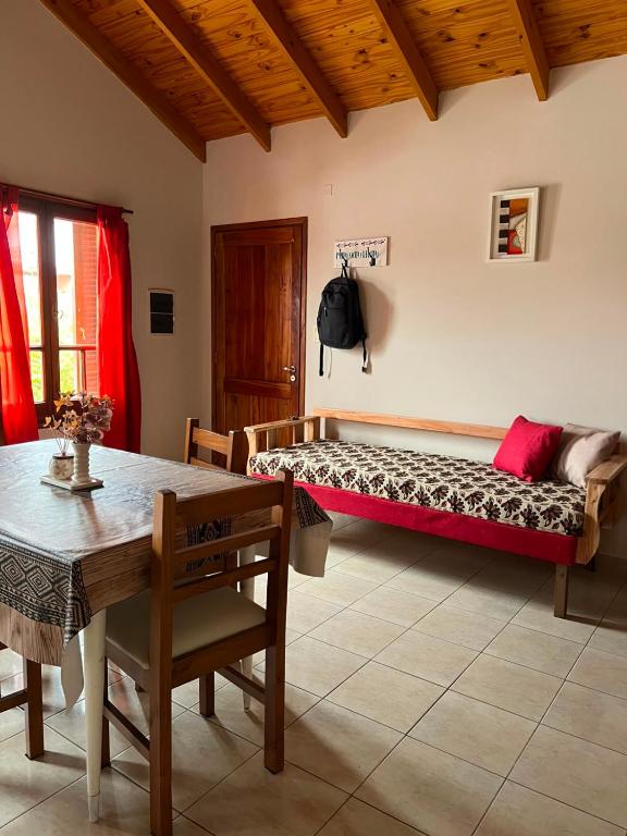 a living room with a bench and a table at Complejo Punto Medio in Santa Rosa
