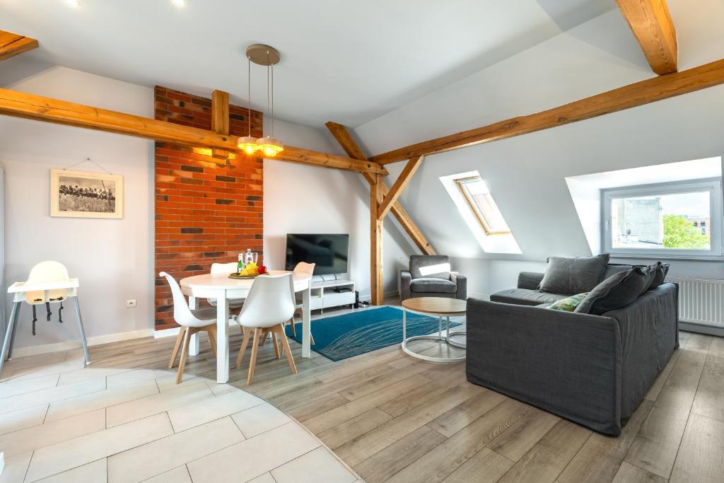 a living room with a couch and a table at Apartamenty Centrum - Moonlight in Opole