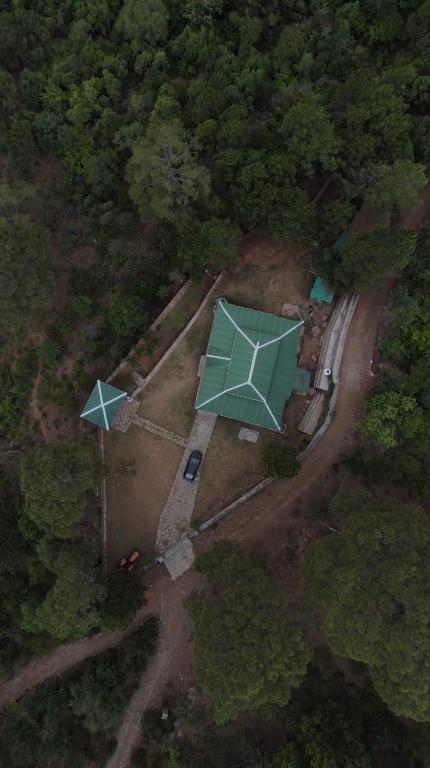 an aerial view of a house with a green roof at Brookside Pines in Murree