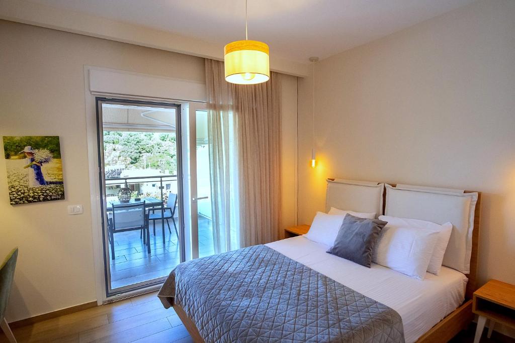 a hotel room with a bed and a balcony at Rousis Studios in Parga