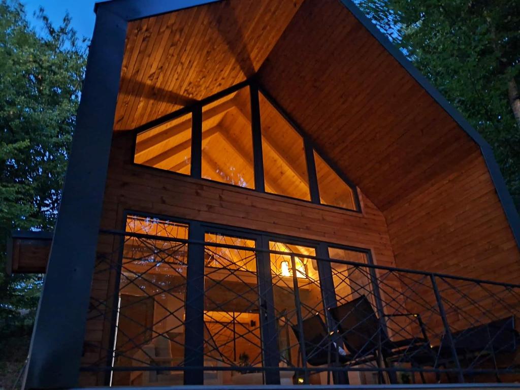 a house with a large window on the side of it at Love Cabin in Slatina Varoš