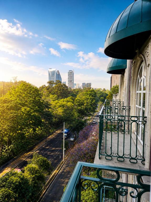 a balcony of a building with a view of a street at The Green Park Boutique Hotel and Grand Suites - Chapultepec Parkfront in Mexico City