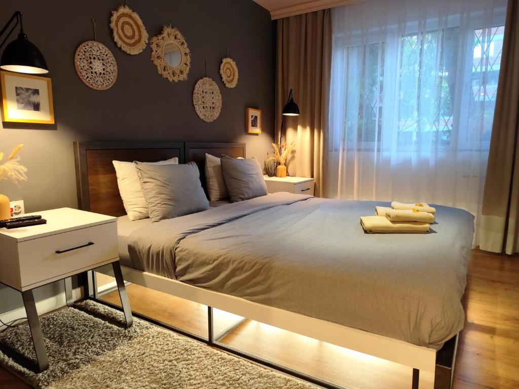 a bedroom with a bed with two towels on it at Mila Apartment in Skopje