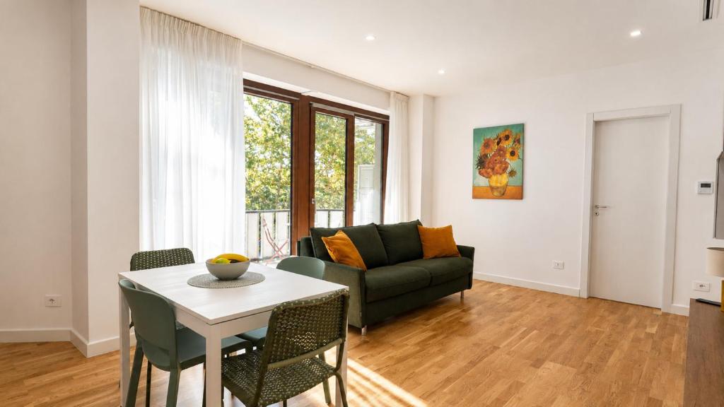 a living room with a couch and a table at Elegantis Luce di Trastevere Apartment with Terrace - Comfort in Most Charming District in Rome