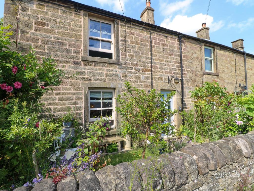 an old brick house with a garden in front of it at Sunnyside in Matlock