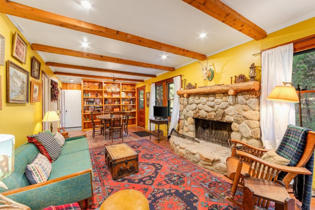 a living room with a stone fireplace at Idyllwild Glory Days in Idyllwild