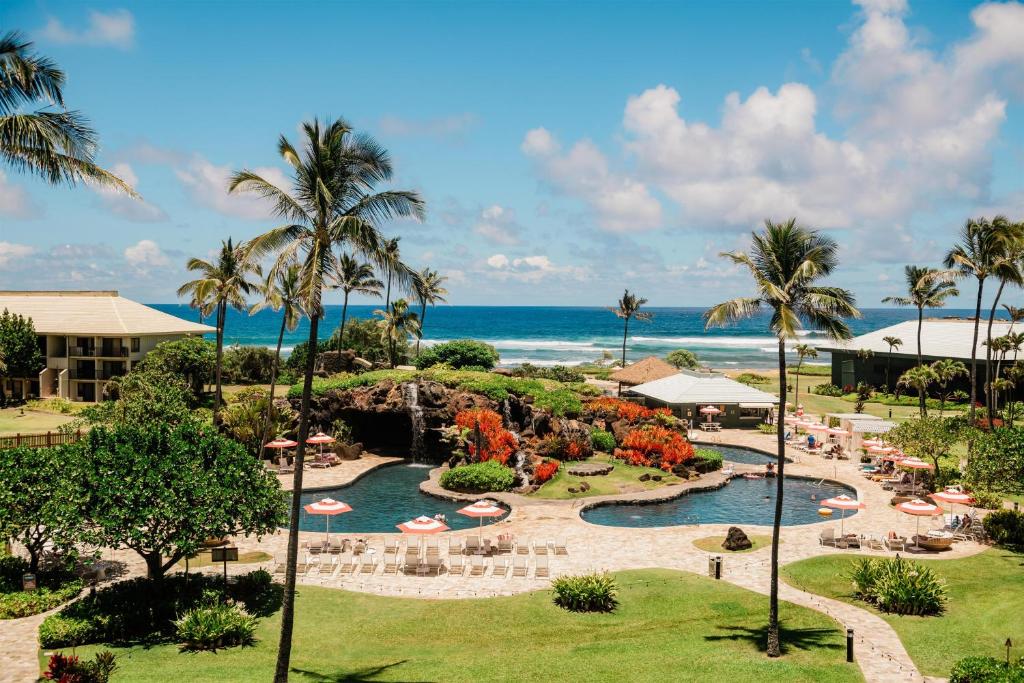 an aerial view of a resort with a pool and the ocean at OUTRIGGER Kaua'i Beach Resort & Spa in Lihue