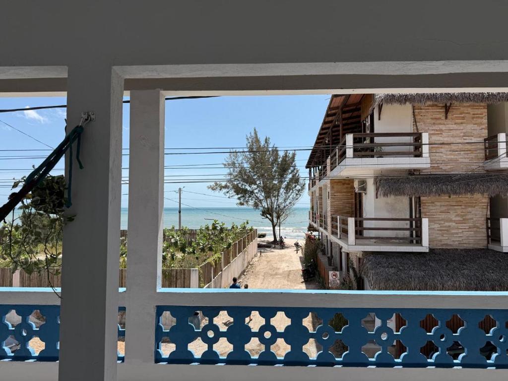 a view of the beach from the balcony of a house at Pousada Flor de Sal in Prea