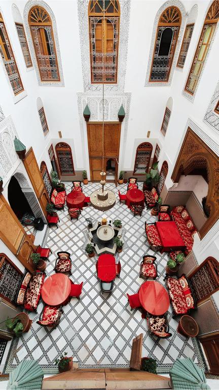 an overhead view of a restaurant with red tables and chairs at Riad Iline fes in Fez