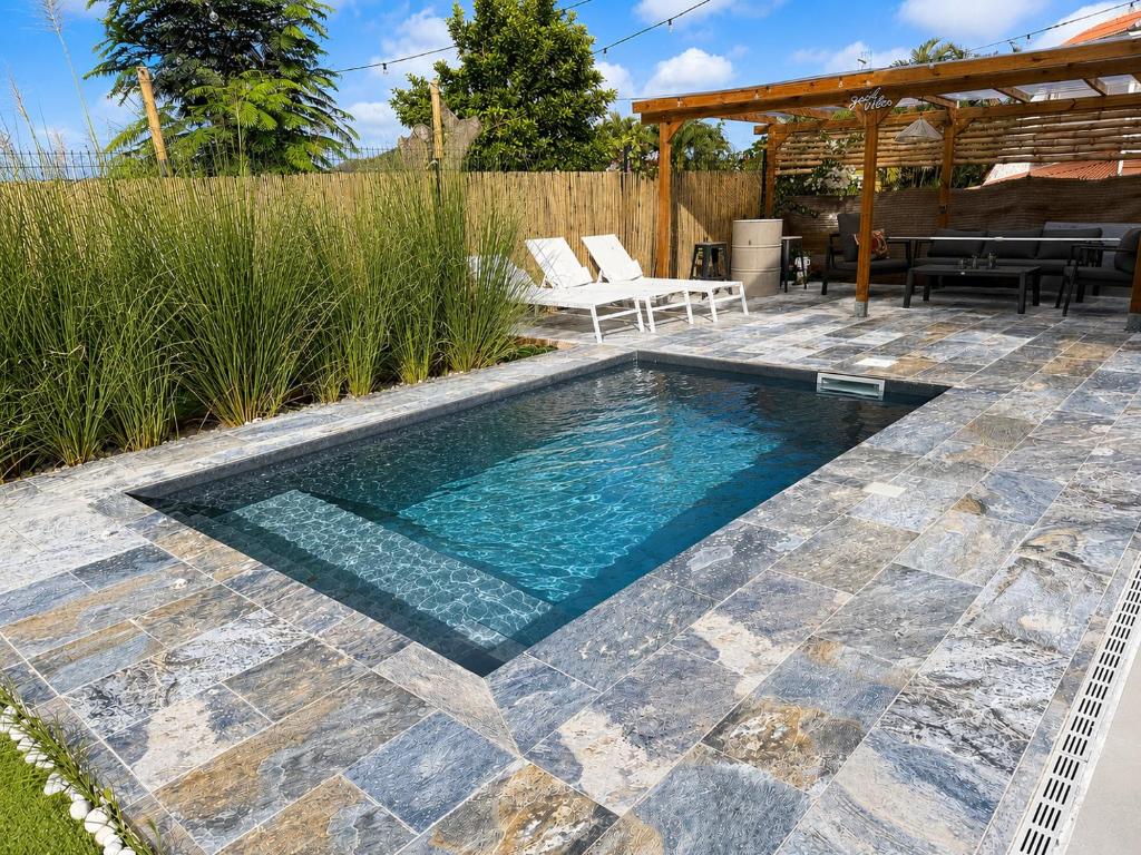 a swimming pool with a patio and a gazebo at Villa Ma Cherry in Le Diamant
