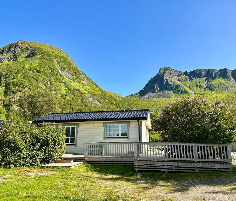 a small house in front of a mountain at Little Paradise in Morfjorden