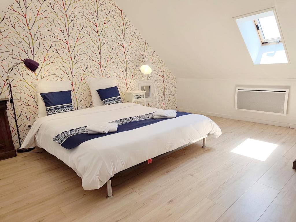 a bedroom with a large bed with a wall at La Salagnac in Corrèze