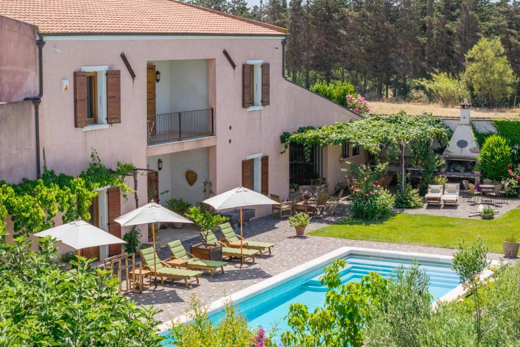 an external view of a house with a swimming pool at Domus Sa Corbula in Oristano