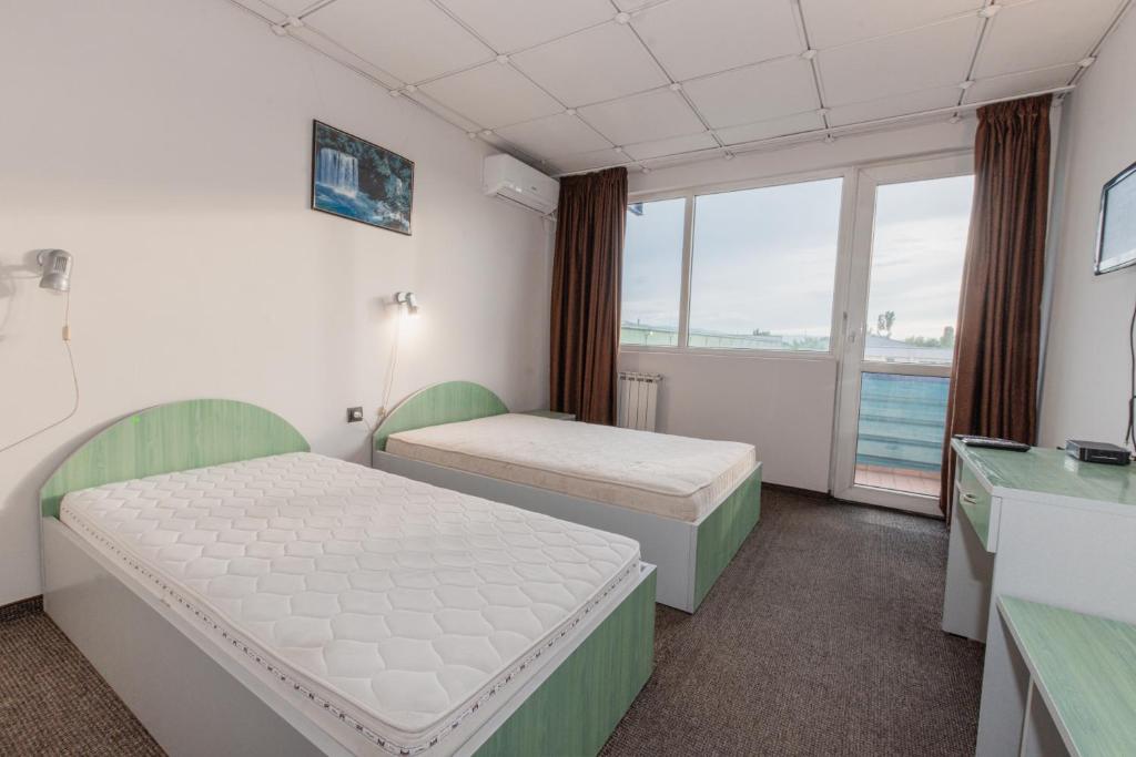 a hospital room with two beds and a window at Rhodopi Hotel Plovdiv in Plovdiv