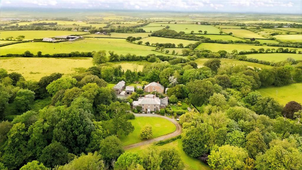an aerial view of a large house in a field at Parnacott in Pancrasweek