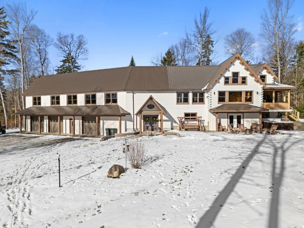 a large white house in the snow at Pleasant View in Island Falls